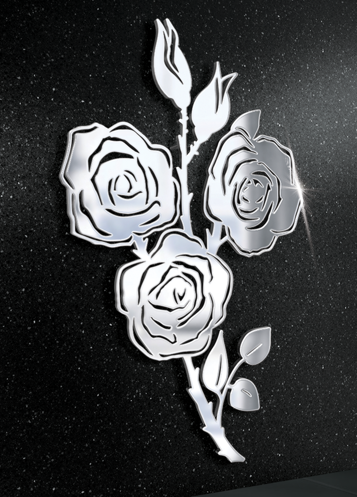 Stalowy ornament trzech róży na tle nagrobka